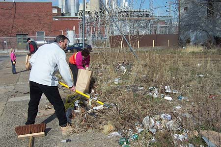 Photo of Ann and John raking debris